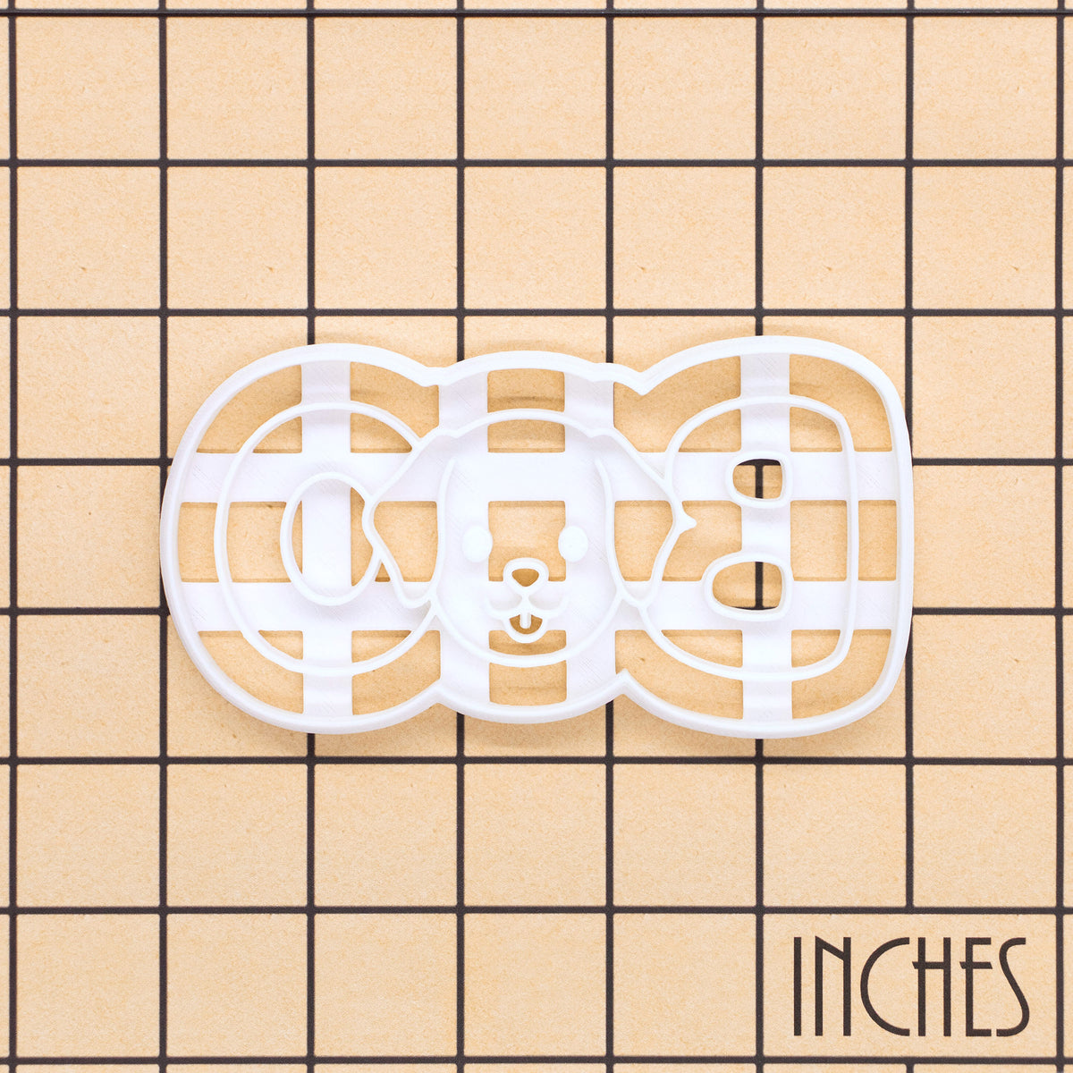BOO dog face cookie cutter shown on inch measurement grid for size reference