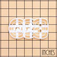 White BOO Paw Print Cookie Cutter with paw pad impression details shown on an inch measurement grid