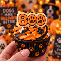 BOO paw print fondant topper on a Halloween cupcake with orange icing, black paw print decorations and pet party background