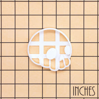 Cute Skull side view cookie cutter shown on an inch measurement grid