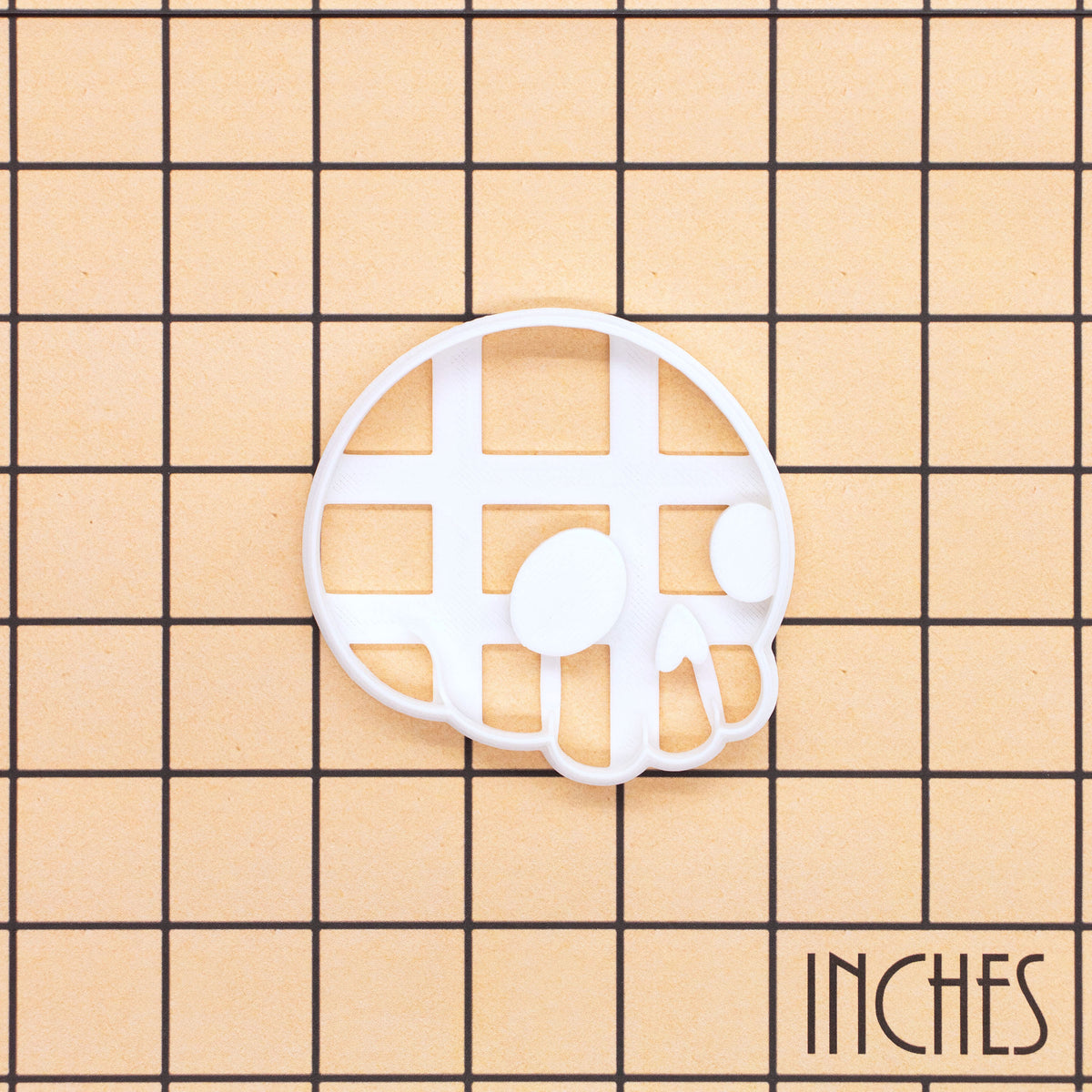 Cute Skull side view cookie cutter shown on an inch measurement grid