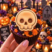 Cute skull mini cookie used as a Halloween cupcake topper in graveyard setting
