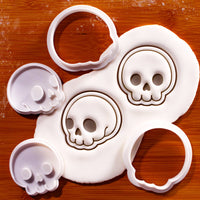 Front & side view cute skull mini cutter and stamp set with fondant impression on wooden board