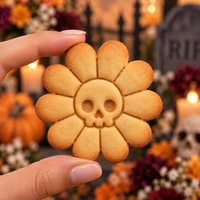 Daisy Skull Halloween cookie with flower petals and skull face in gothic graveyard setting