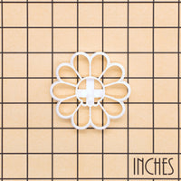 White Daisy Skull cookie cutter on inch grid showing gothic floral skull design