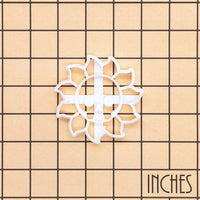 White Skull Sun cookie cutter on inch grid showing gothic celestial skull design