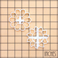 Daisy Skull and Skull Sun cookie cutter set on inch grid showing floral and solar designs