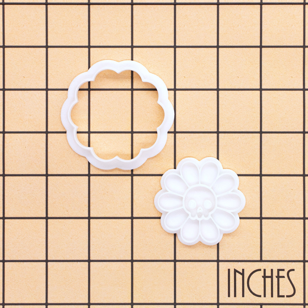 Daisy Skull Mini cookie cutter and stamp set on inch grid showing 2-piece floral skull design