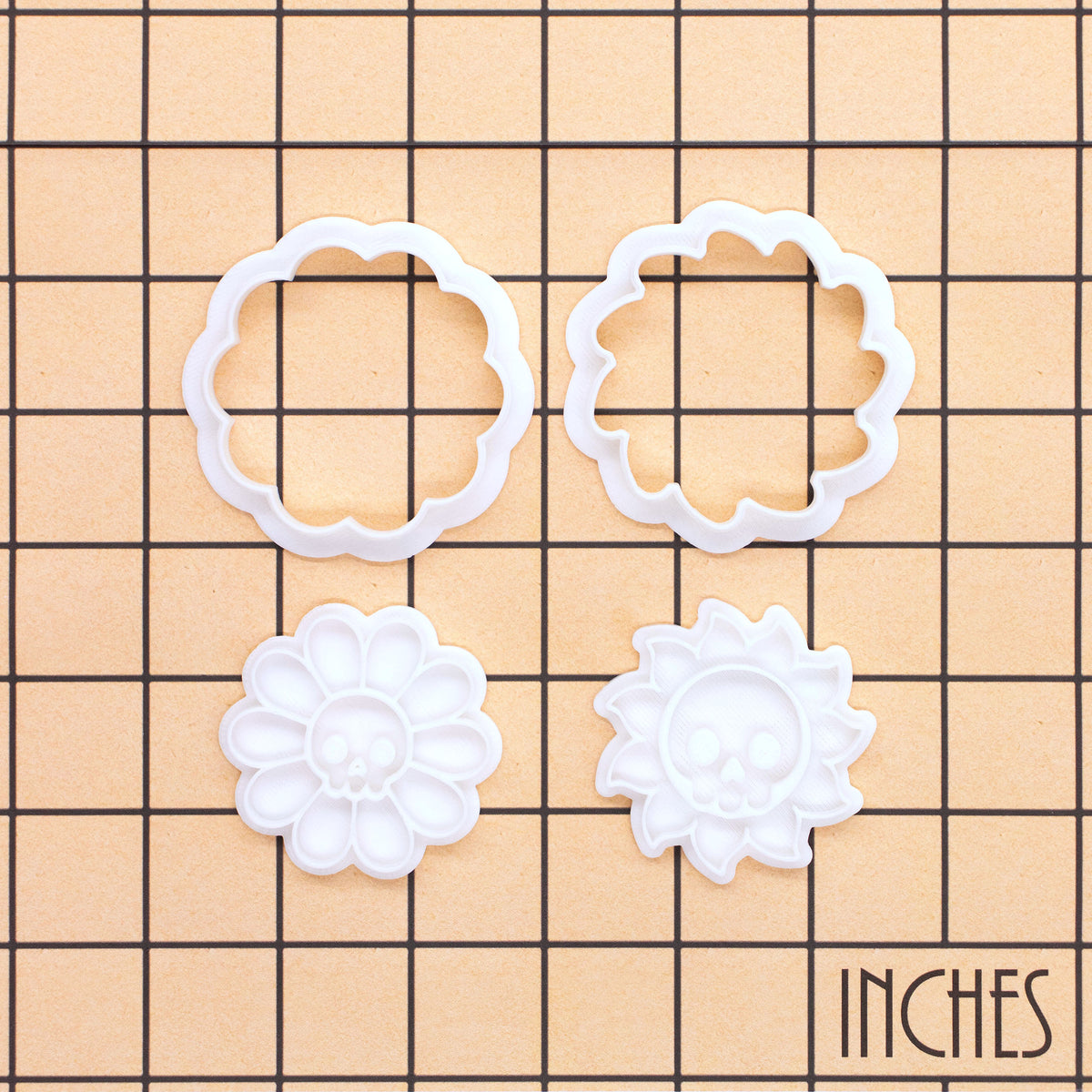 Daisy Skull and Skull Sun Mini cookie cutter and stamp sets on inch grid showing 4-piece set
