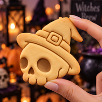 Skull with Witch Hat Halloween cookie held by hand in spooky witchy setting