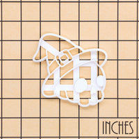 White Skull with Witch Hat cookie cutter on inch grid for Halloween baking