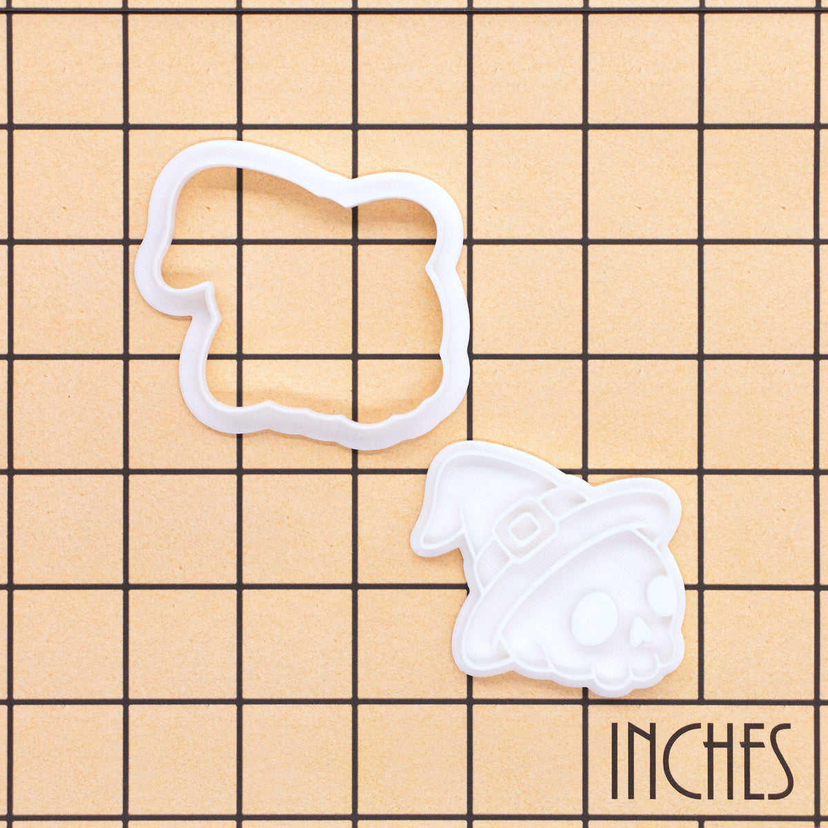 Skull with Witch Hat mini cookie cutter and stamp set on inch grid background