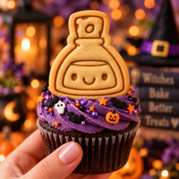 Smiling potion mini cookie topper on purple frosted Halloween cupcake