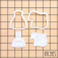 Skull Witch Hat and Smiling Potion Mini cutter and stamp sets on inch grid showing 4 pieces