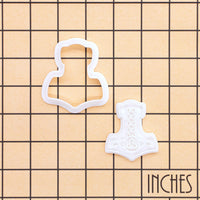 Mjolnir mini cookie cutter and impression stamp shown on inch measurement grid