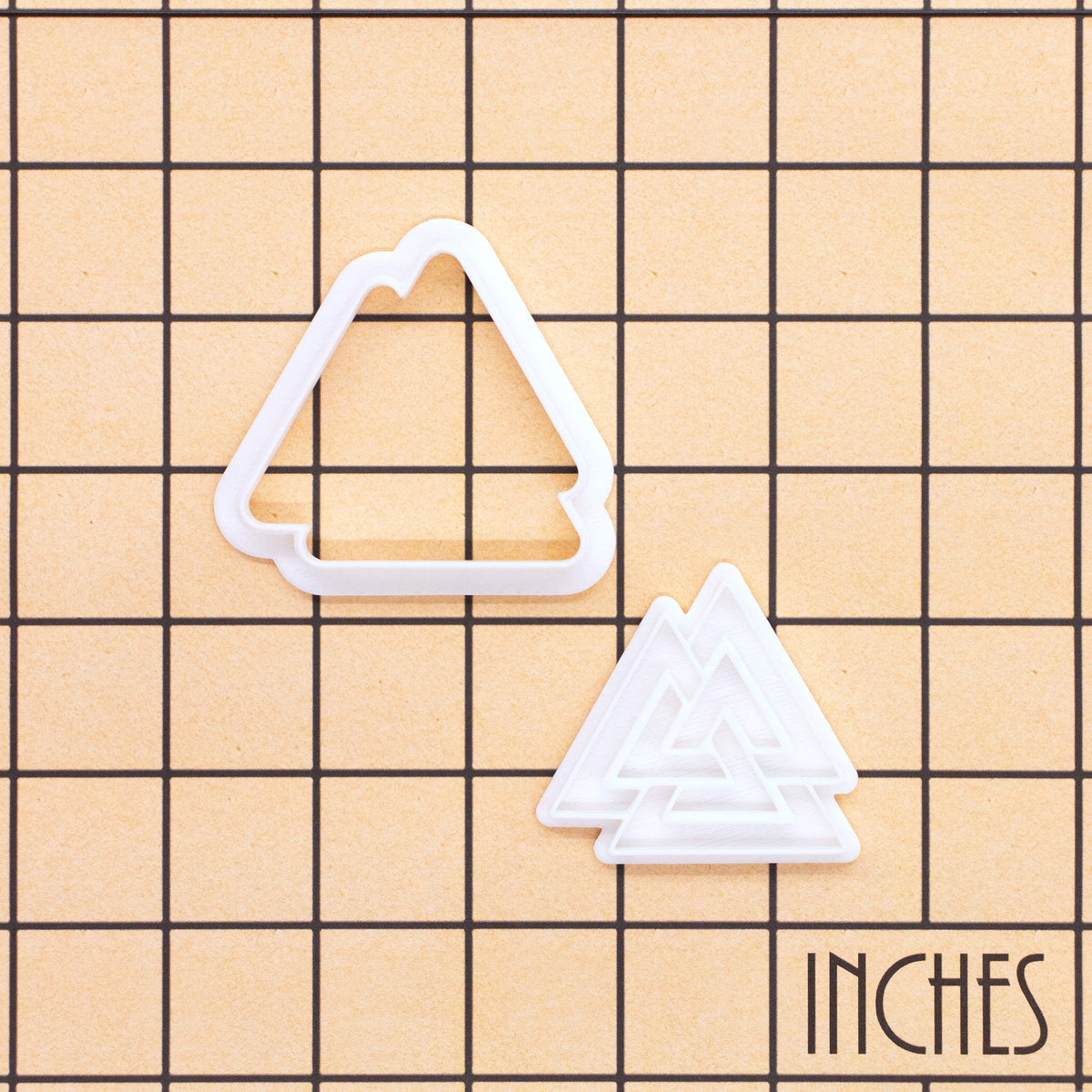 Valknut mini cookie cutter and impression stamp shown on inch measurement grid