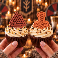 Mjolnir and Valknut fondant cupcake toppers on Viking themed cupcakes with candlelit medieval background