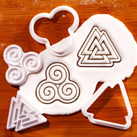 Triskelion and Valknut mini cookie cutter and stamp set with fondant impressions on wooden board