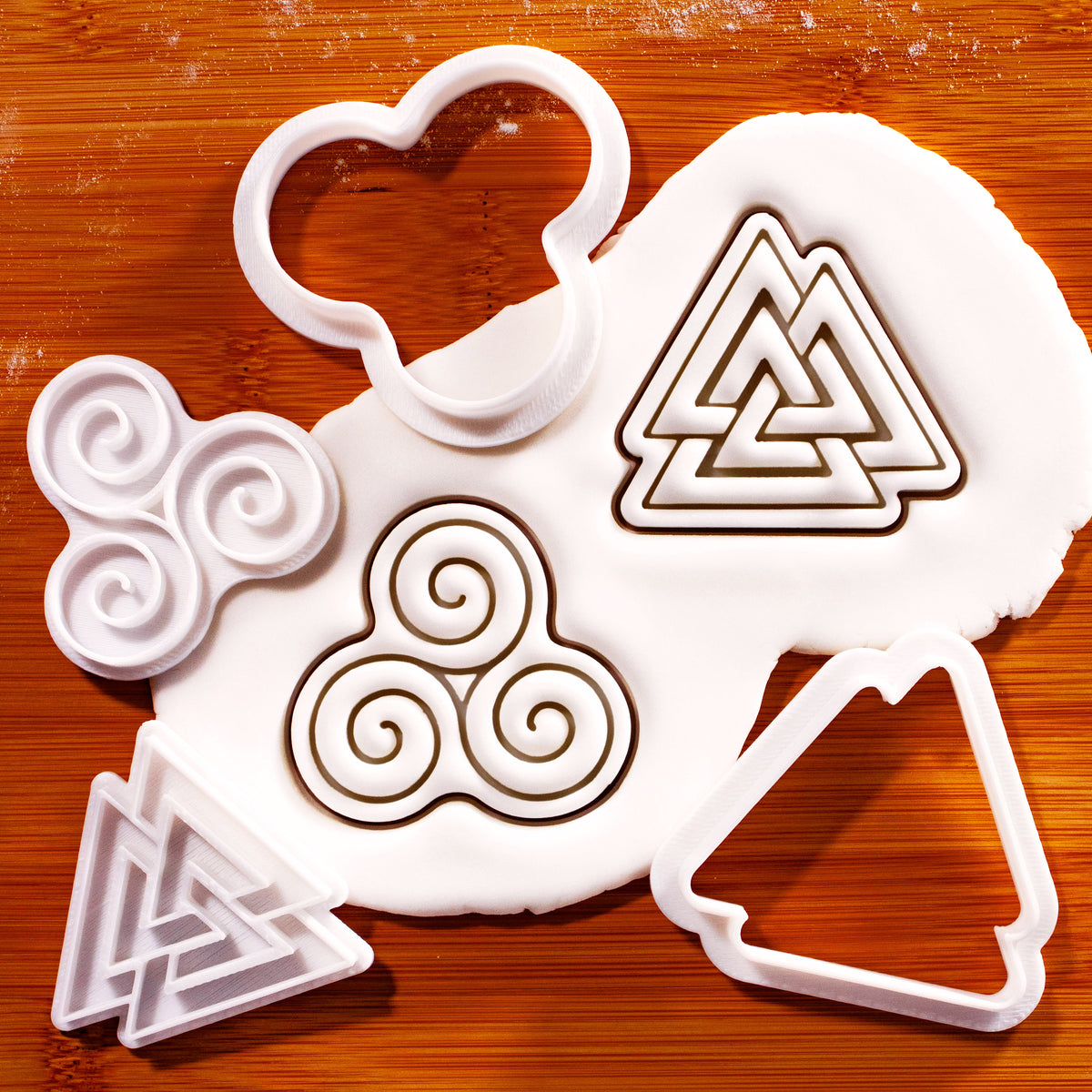 Triskelion and Valknut mini cookie cutter and stamp set with fondant impressions on wooden board