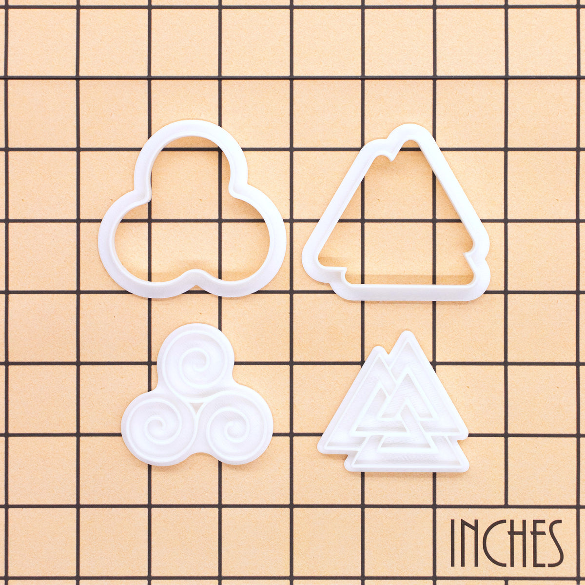 Triskelion and Valknut mini cookie cutter and stamp set of 2 shown on inch grid for size reference