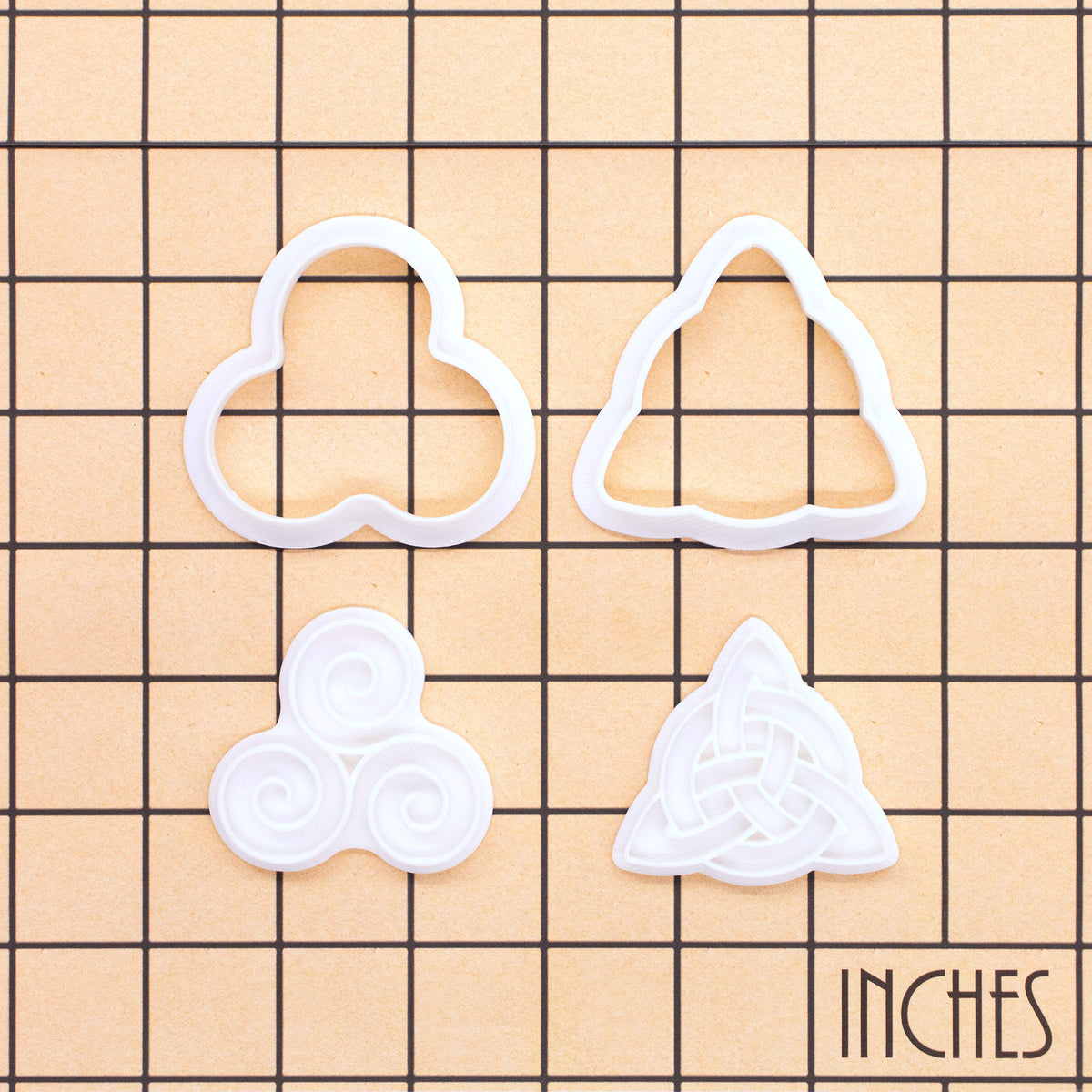 Triskelion and Celtic Triquetra mini cookie cutter and stamp set on inch grid for size reference