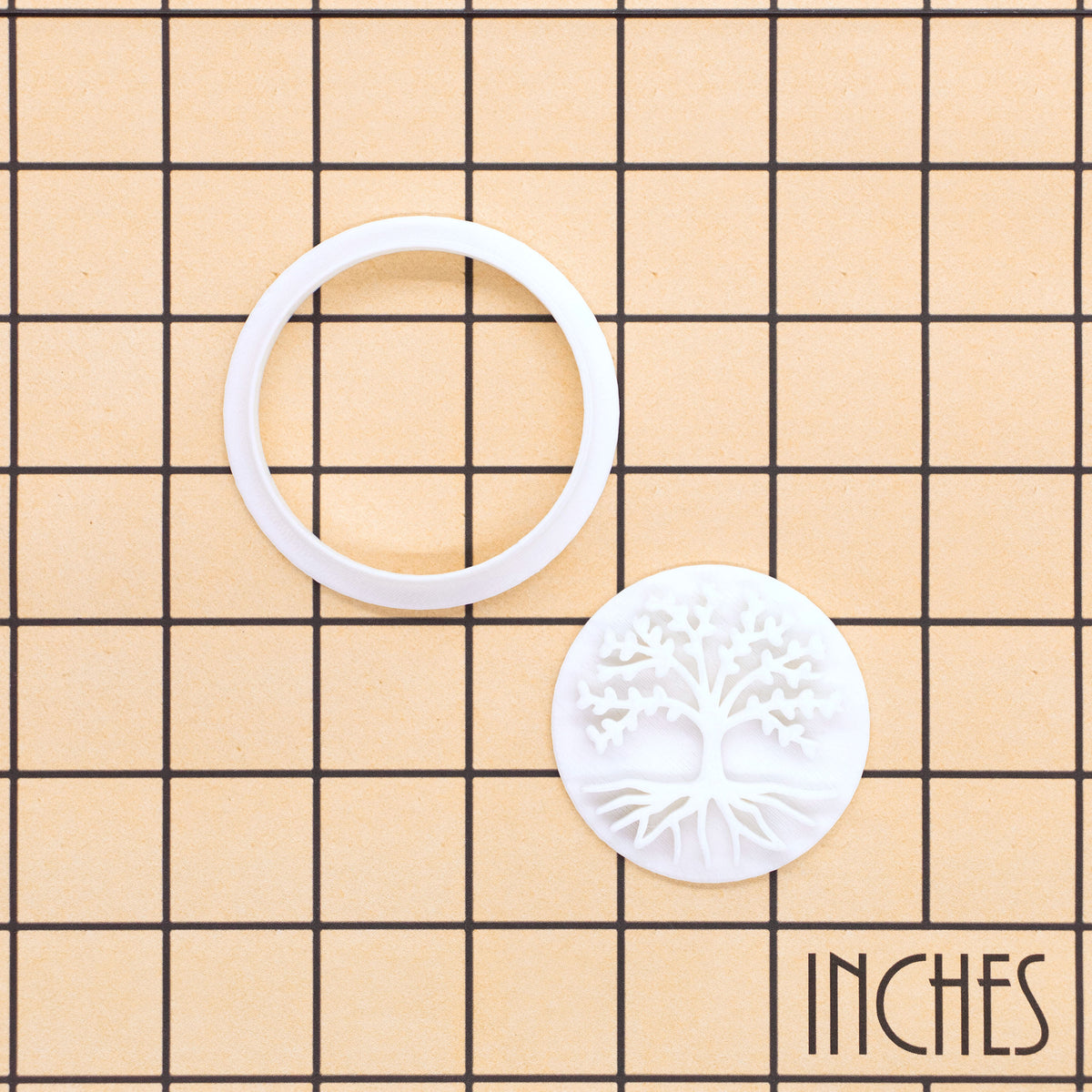 Tree of Life mini cookie cutter and separate impression stamp shown on inch measurement grid