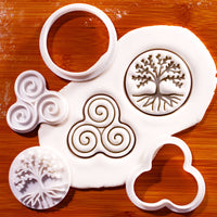 Tree of Life and Triskelion mini cookie cutter and stamp set with fondant impressions on wooden background
