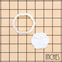 Camellia flower mini cookie cutter and impression stamp shown on inch grid