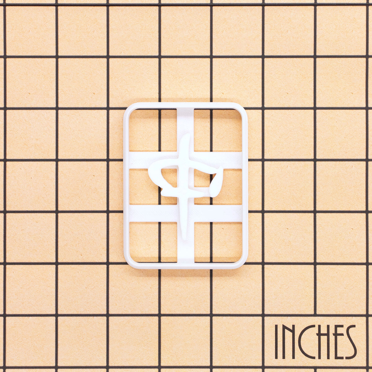 Red Dragon Zhong mahjong cookie cutter shown on inch measurement grid