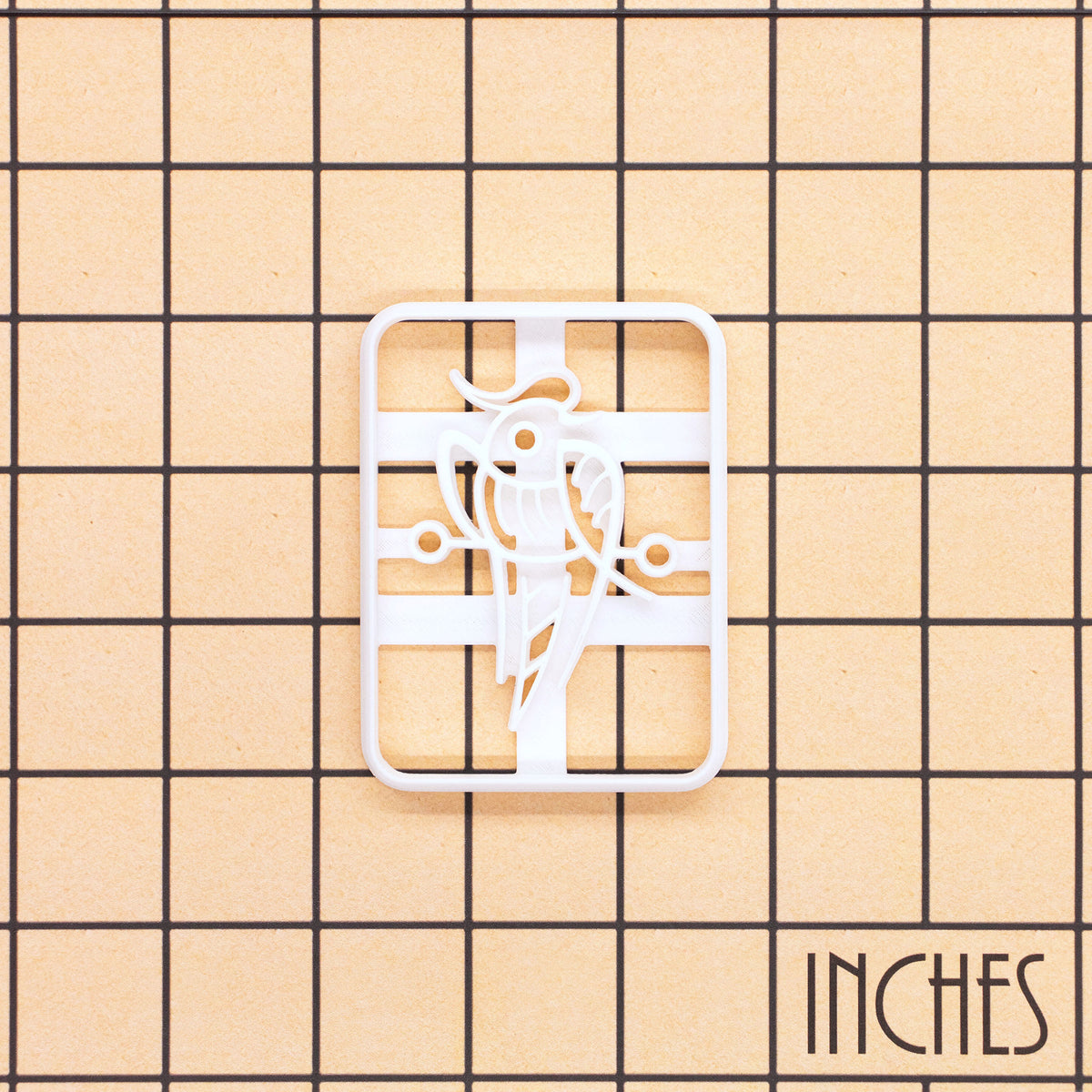 Large 1 Bamboo mahjong cookie cutter shown on inch measurement grid