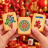 Three decorated mahjong cookies with 1 Bamboo 1 Circle and 1 Character icing designs