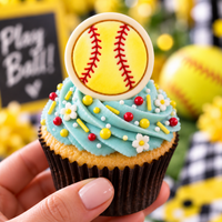 Decorated softball mini cookie topper with yellow icing and red stitching on cupcake
