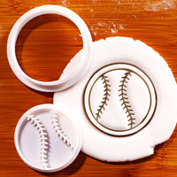 Softball mini cookie cutter and impression stamp shown with stamped fondant