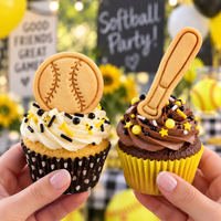 Softball ball and bat stamped cookies displayed on sports themed cupcakes