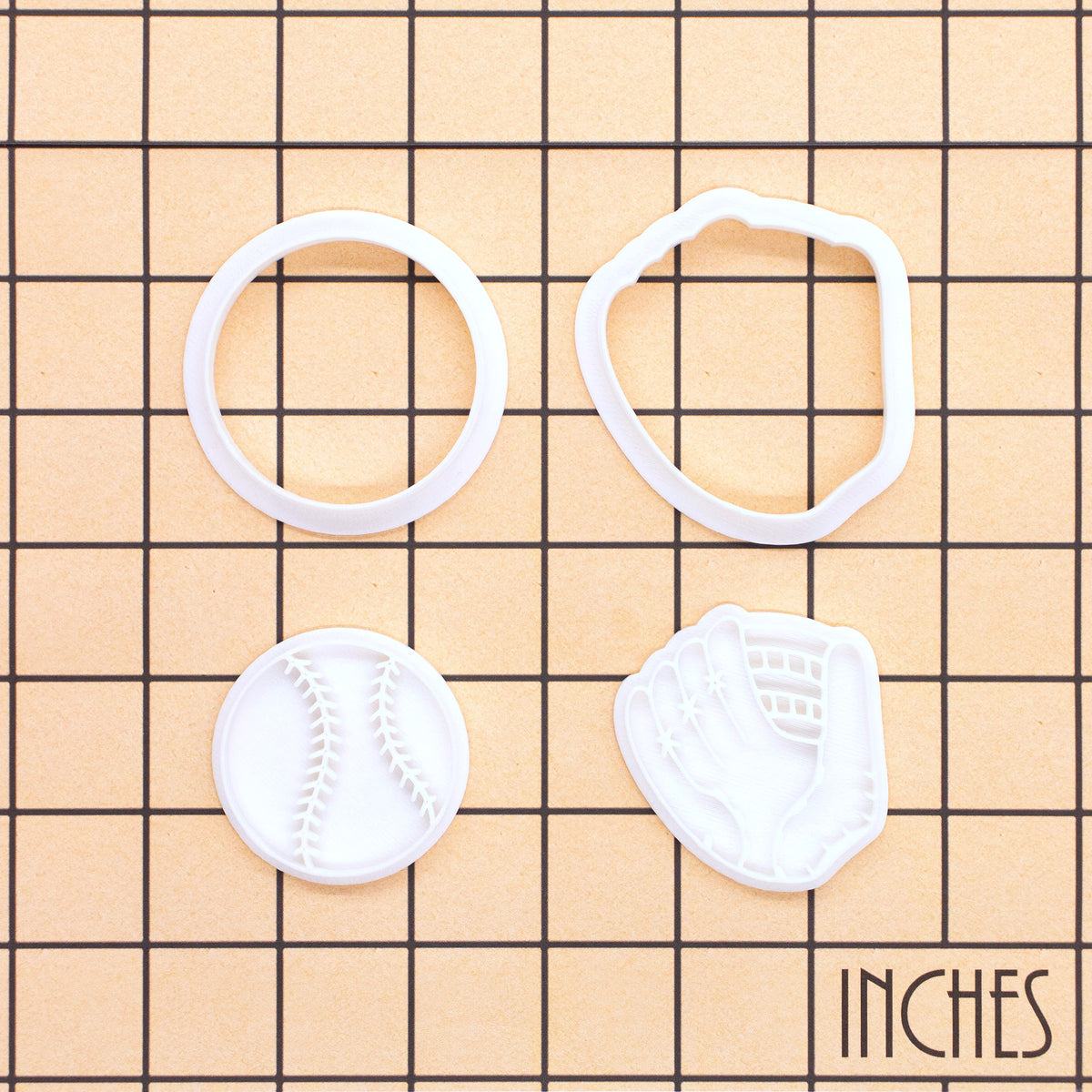 Softball and glove mini cookie cutter and stamp set shown on inch measurement grid