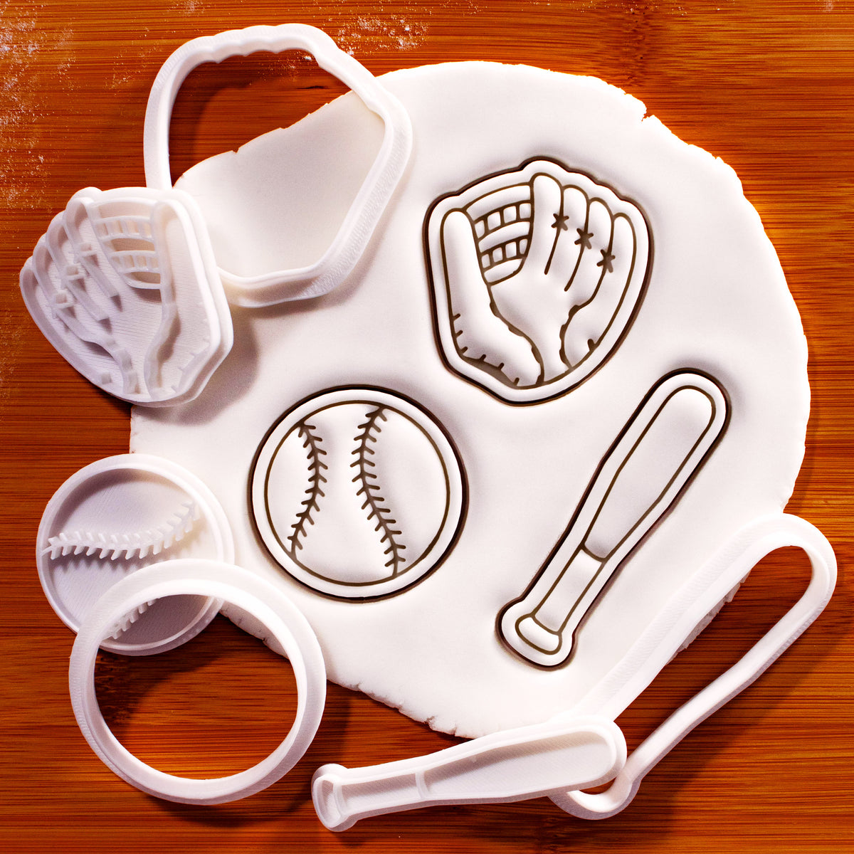 Softball bat and glove mini cookie cutter and stamp set shown with stamped fondant