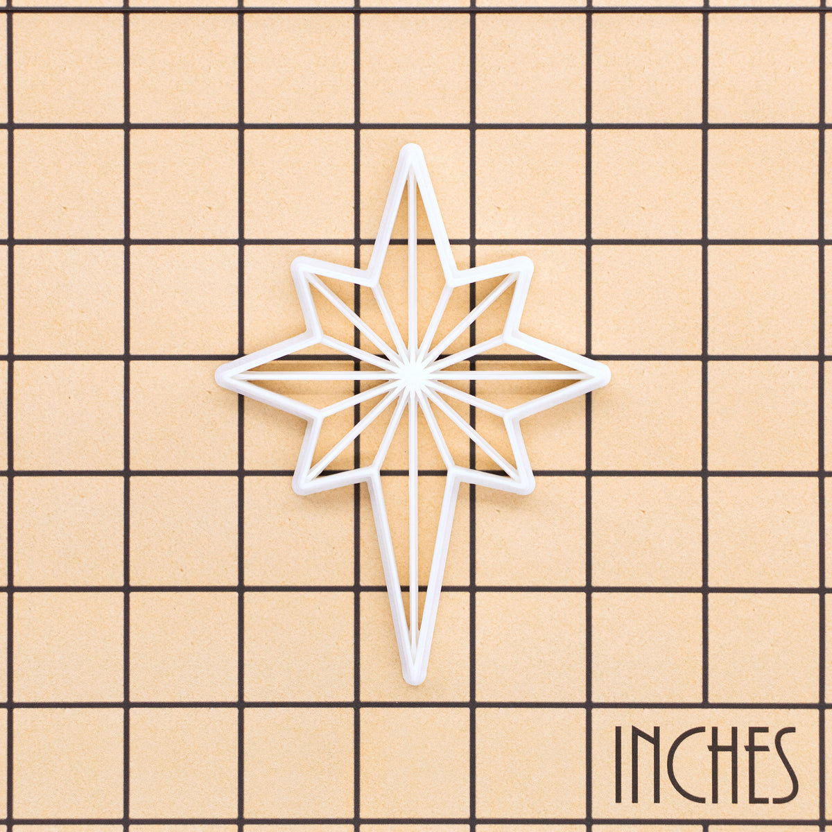 Star of Bethlehem Christmas cookie cutter shown on inch measurement grid for size reference