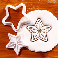 Five-point star mini cookie cutter and stamp set with detailed geometric star impression in fondant