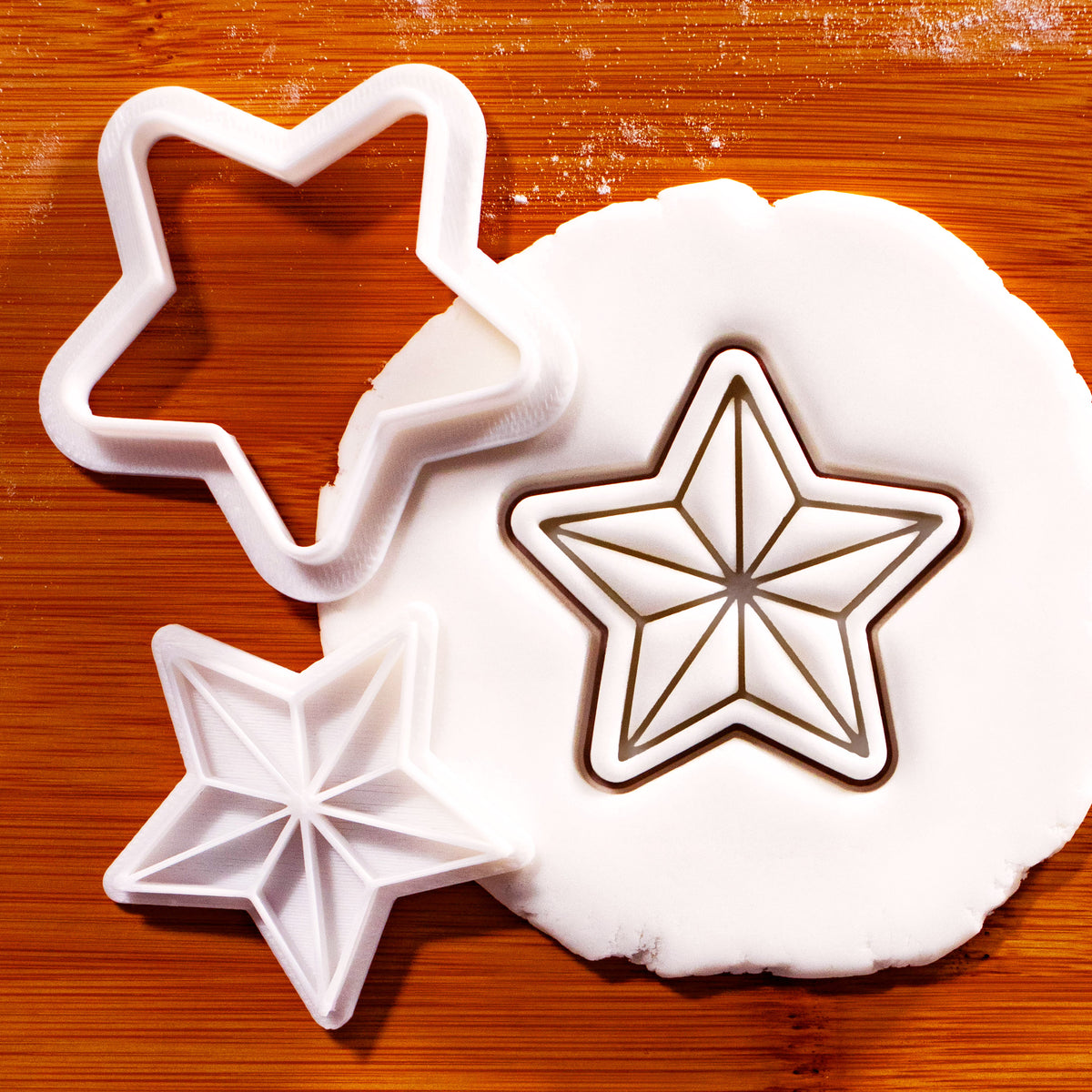 Five-point star mini cookie cutter and stamp set with detailed geometric star impression in fondant