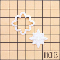 Eight-point star mini cookie cutter and stamp set shown on inch grid for size reference