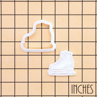 Ice skate mini cookie cutter and stamp set shown on inch grid for size reference