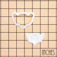 Angel heart with wings mini cookie cutter and stamp set shown on inch grid for size reference