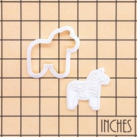 Dala horse mini cookie cutter and stamp set shown on inch grid for size reference