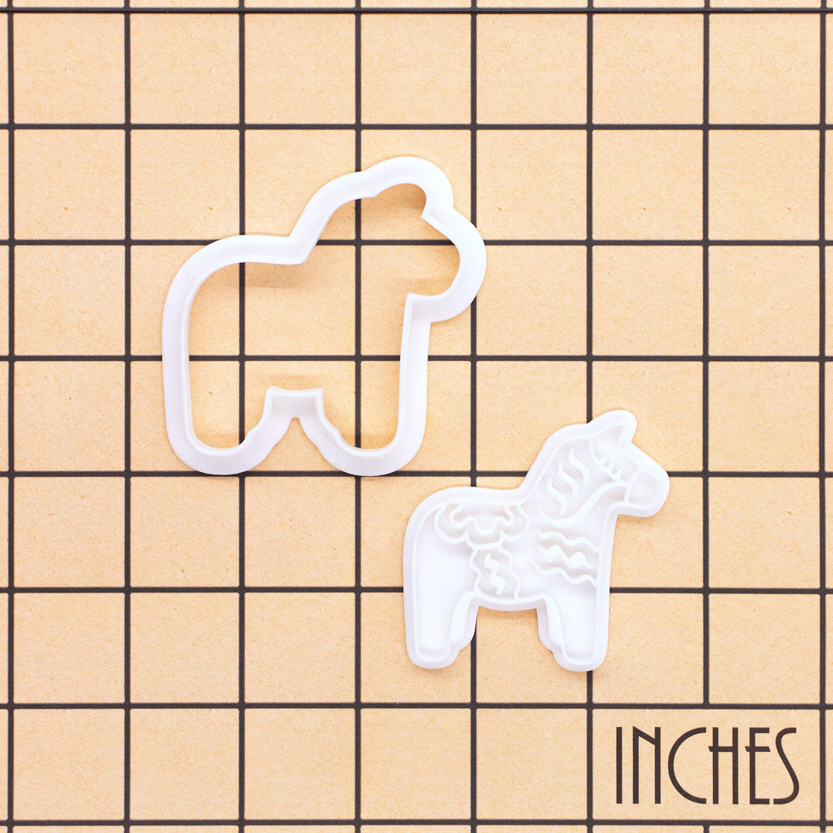 Dala horse mini cookie cutter and stamp set shown on inch grid for size reference