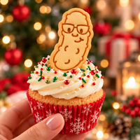 Nerdy Christmas pickle cookie with glasses used as a festive cupcake topper