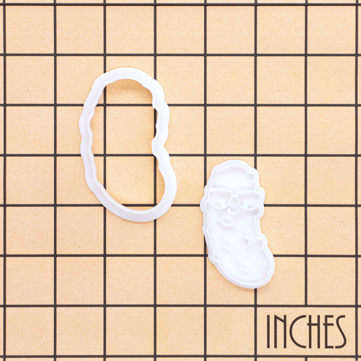 Christmas pickle mini cookie cutter and stamp set with glasses shown on inch grid for size reference