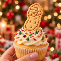 Christmas pickle cookie with Santa hat and glasses used as a festive cupcake topper