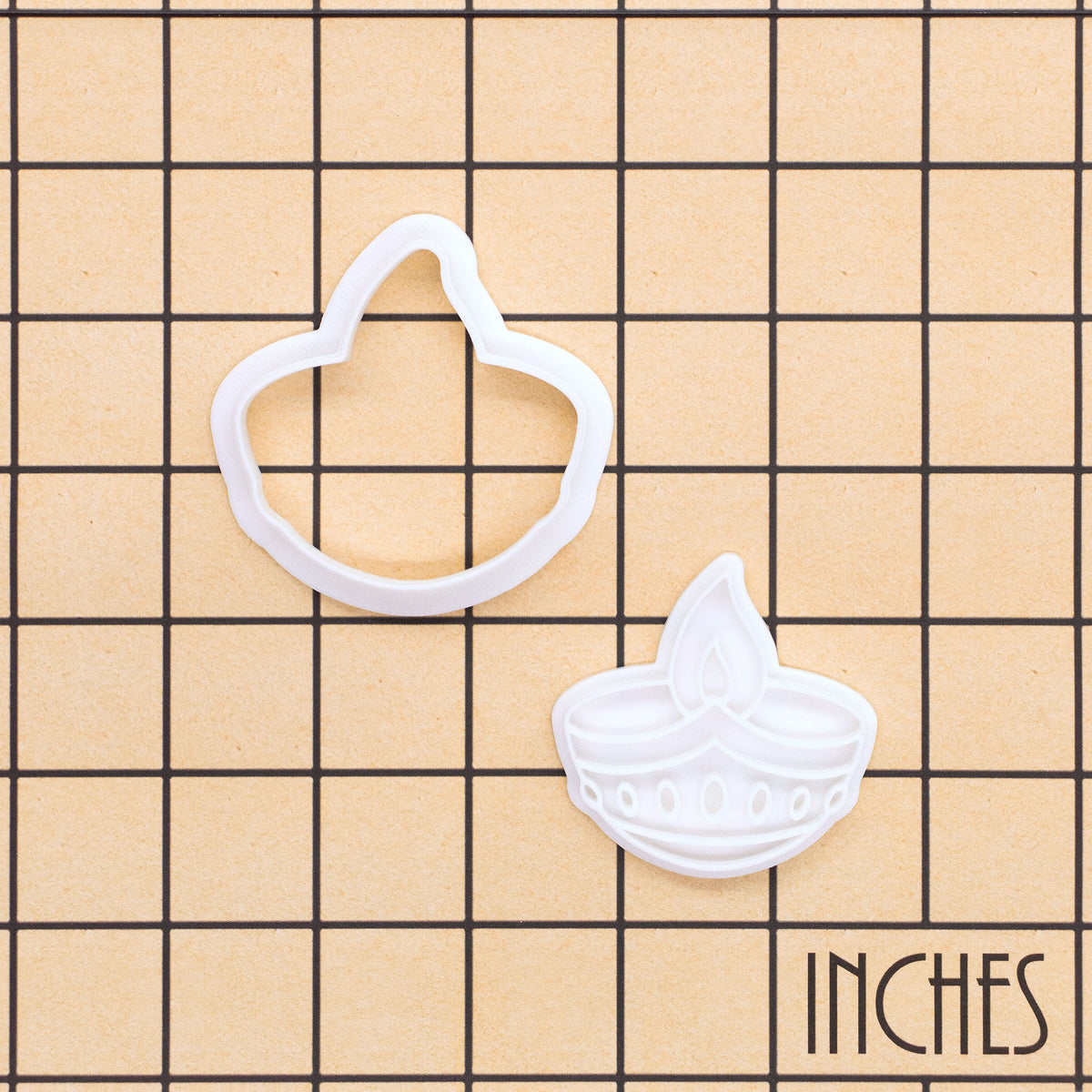 Diya oil lamp mini cookie cutter and stamp set shown on inch grid for size reference