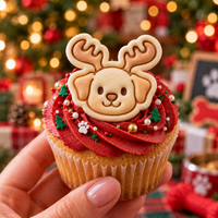 Cute reindeer puppy cookie on festive Christmas cupcake with antlers for holiday baking