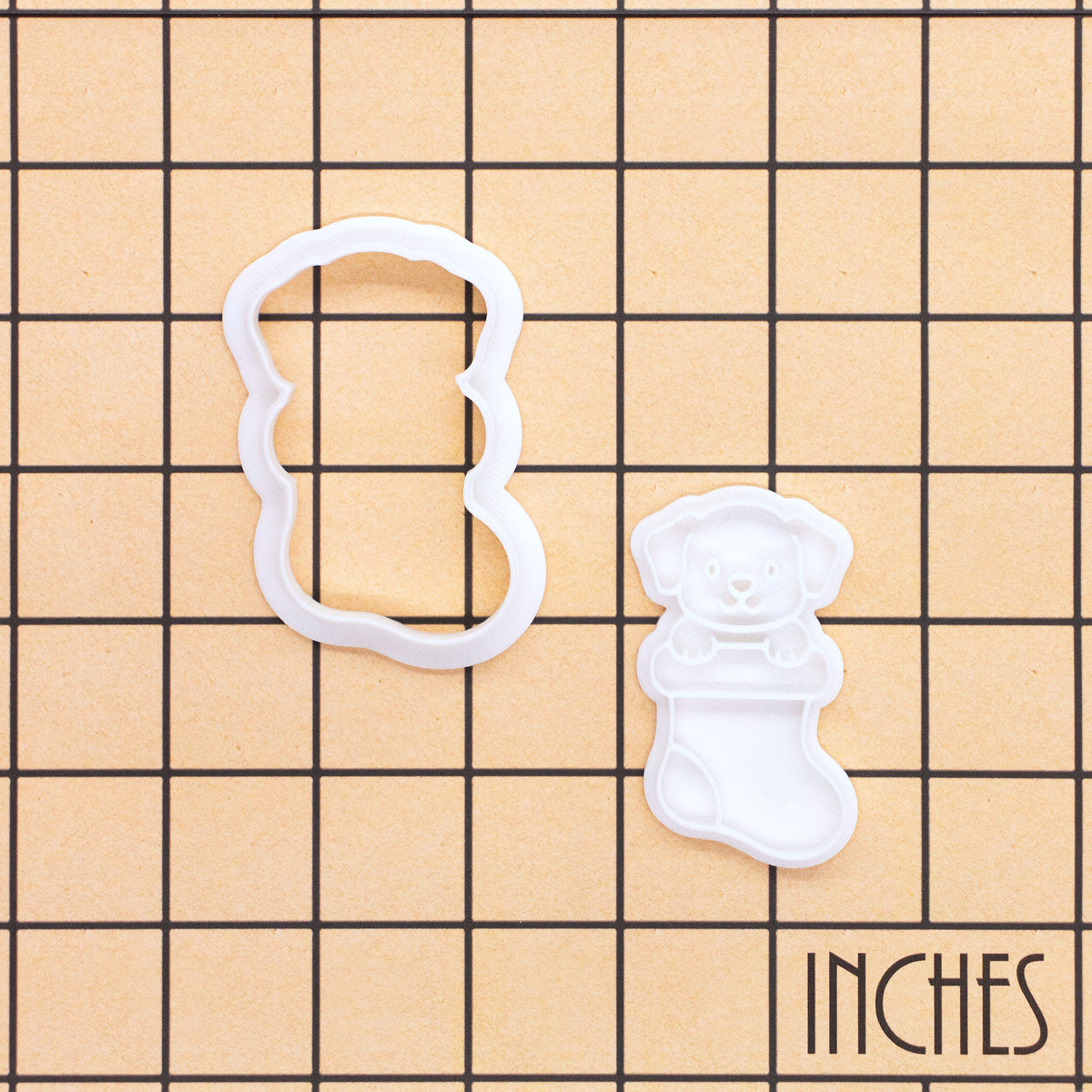 Puppy in Christmas stocking mini cookie cutter and stamp set shown on inch grid for size reference